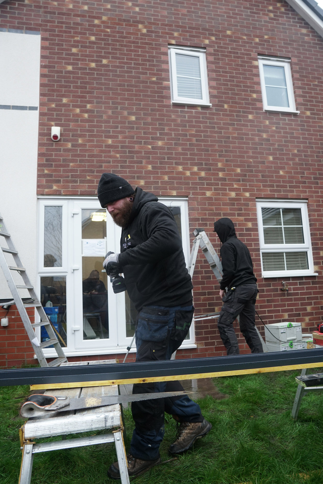 Fleming Verandas surveyor assessing existing patio condition and drainage for veranda installation