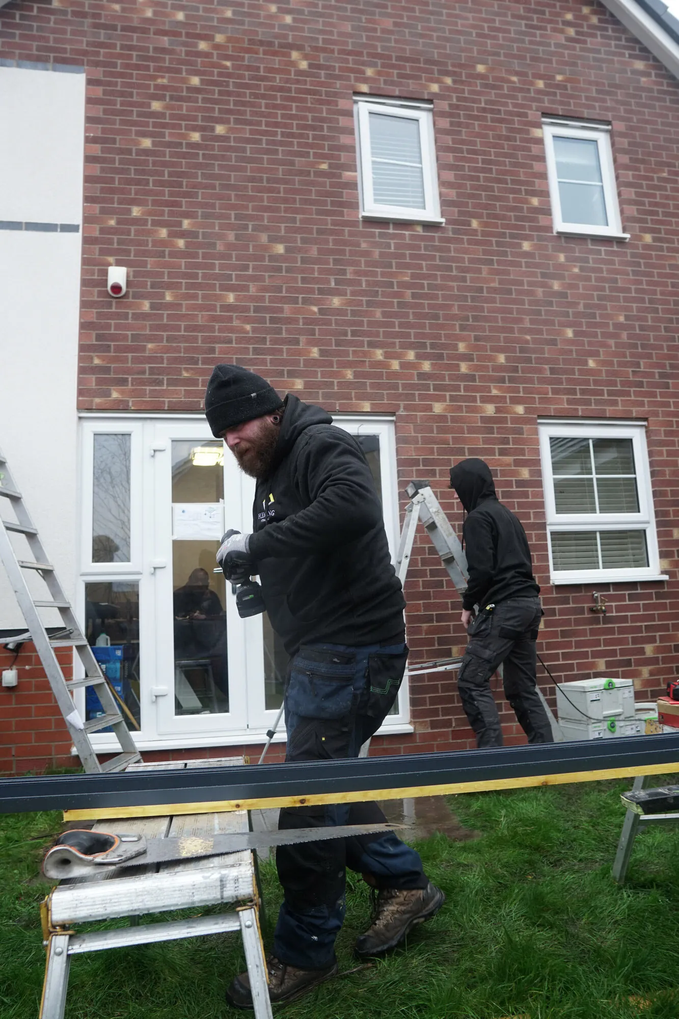 Fleming Verandas surveyor assessing existing patio condition and drainage for veranda installation