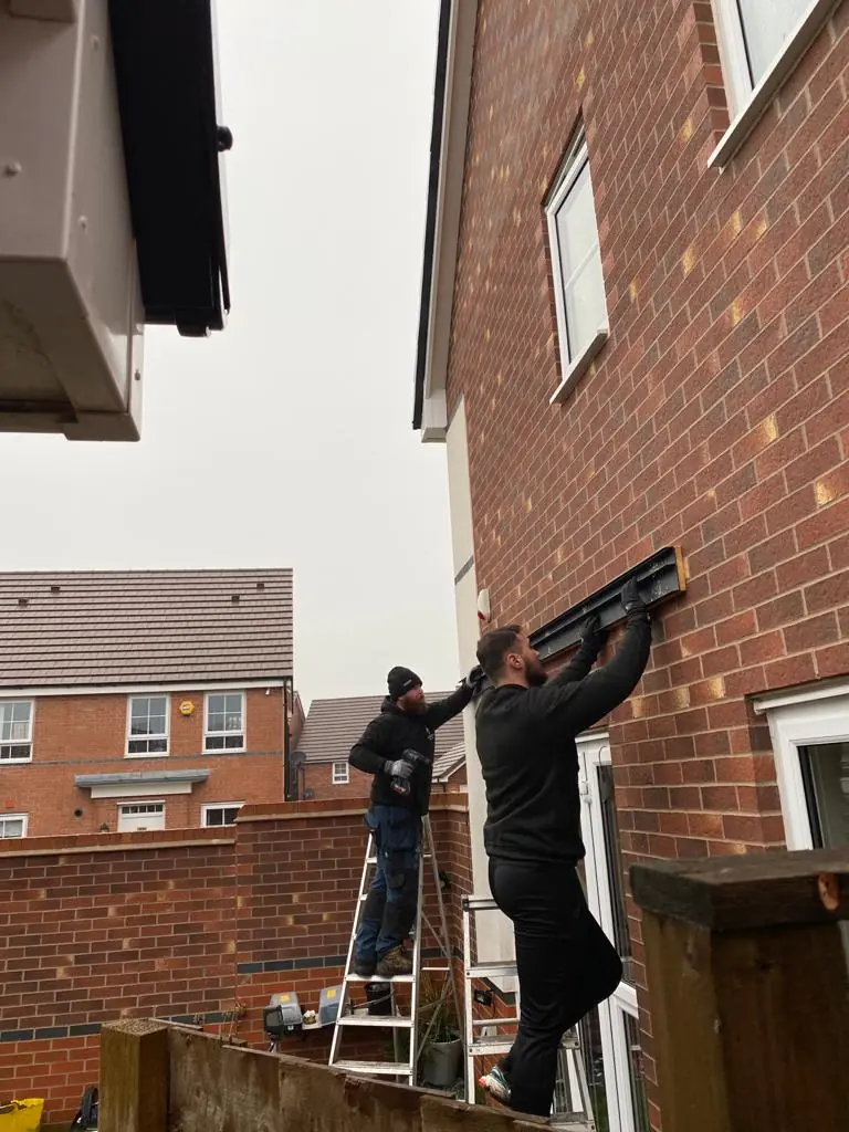 Fleming Verandas installer working alongside landscaper during patio and veranda installation